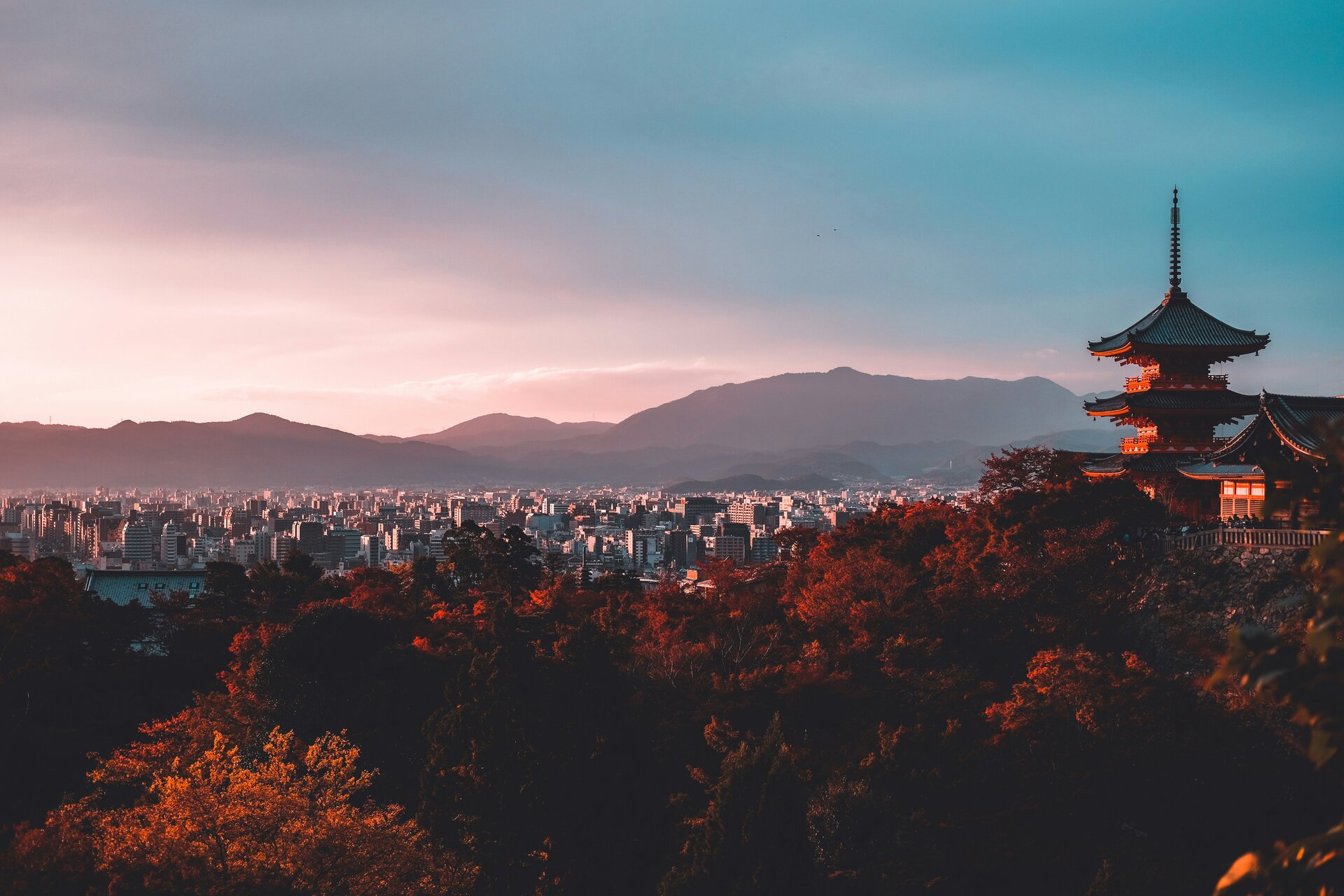 Pagoda overlooking a city at sunset